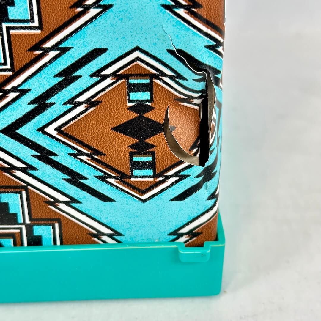 Close-up of a product with a geometric pattern and turquoise border on a white background