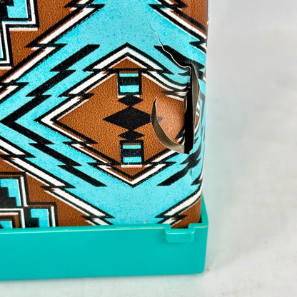Close-up of a product with a geometric pattern and turquoise border on a white background