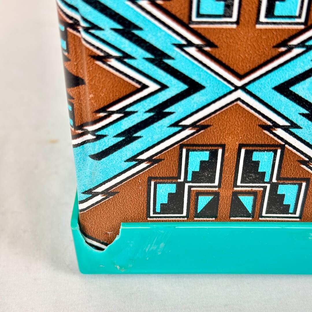 Close-up of a book with a geometric pattern on a light background