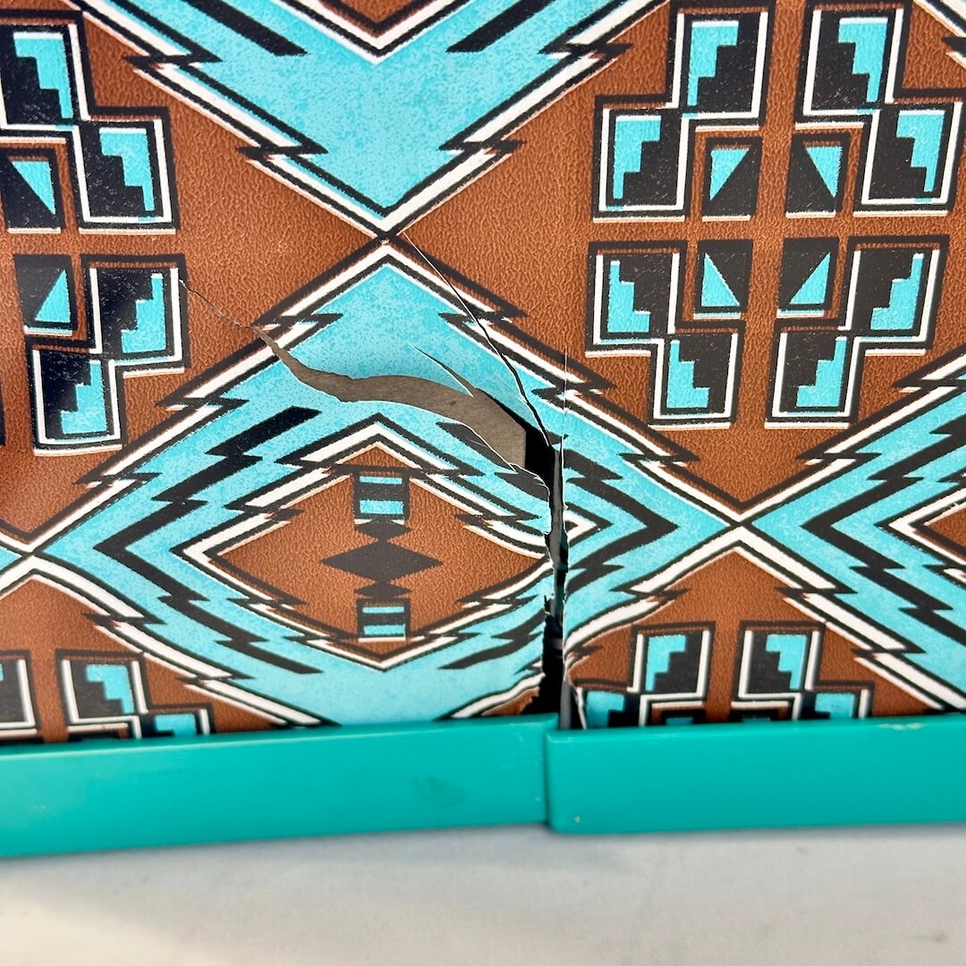 Close-up of a patterned fabric with blue and brown colors.