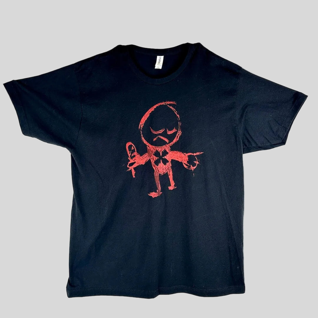 A black short-sleeve t-shirt laid flat on a white background, featuring a red hand-drawn style graphic of a cartoon character.