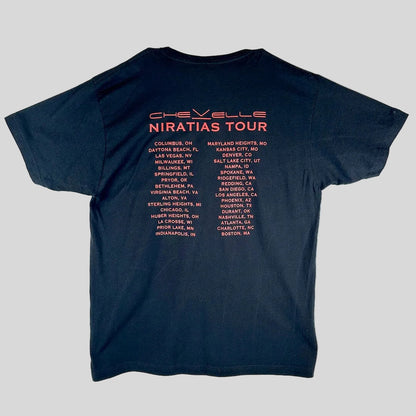 A black short-sleeve t-shirt, showing the back side printed with the words 'Chevelle Niratias Tour' in red and a list of tour cities.