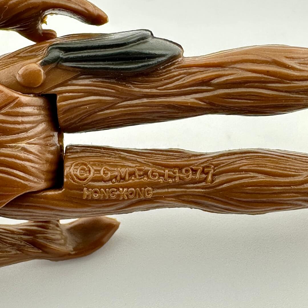 Close-up of back of figure's legs to show COO and copyright information.