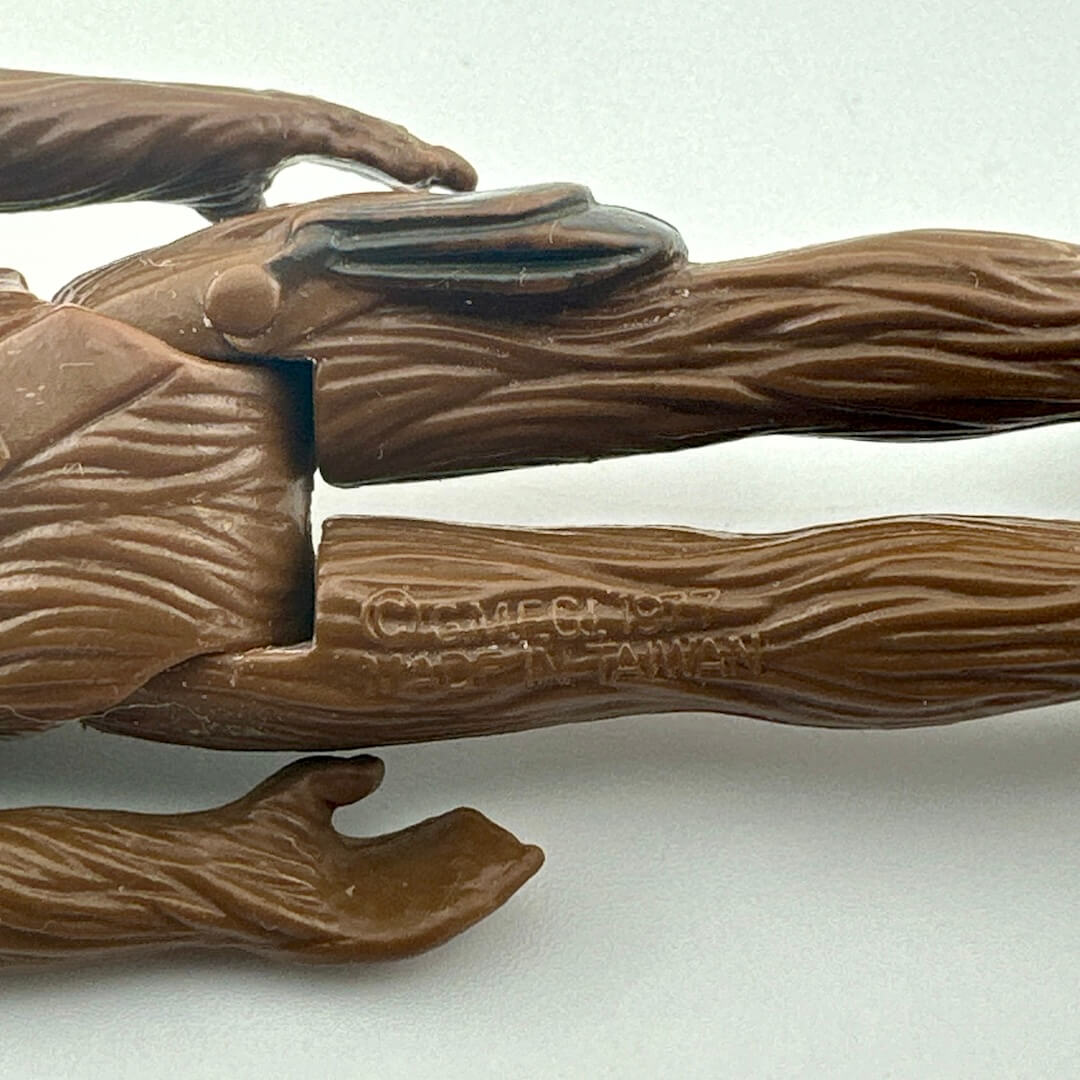 Back of figure's legs to show COO and copyright information. 