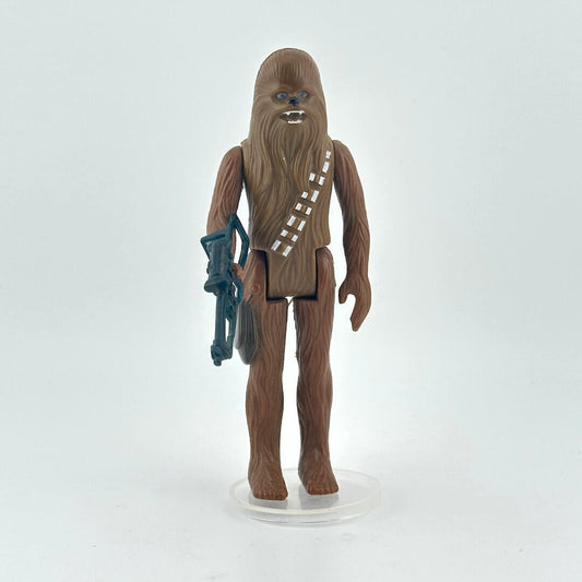 Action figure of Chewbacca and holding a weapon on a white background