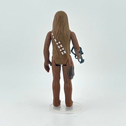 Action figure of Chewbacca and holding a weapon on a white background