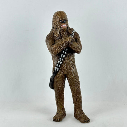 Action figure of a character with a textured brown body and black belt on a white background