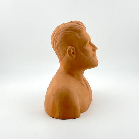 Terracotta-colored bust of a man on a white background