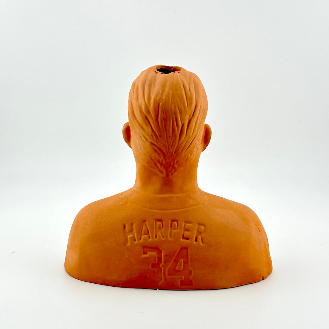 Orange bust sculpture with 'Harper 34' engraving on a white background