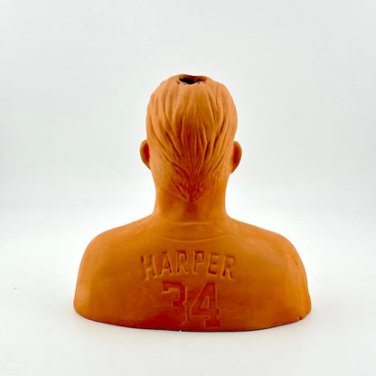 Orange bust sculpture with 'Harper 34' engraving on a white background