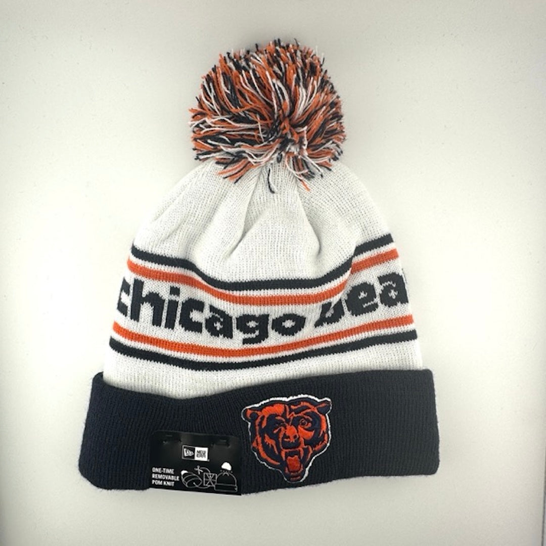 White knit cap with orange/navy stripes around navy text, navy cuff with Bears logo front center & navy/white/orange pom