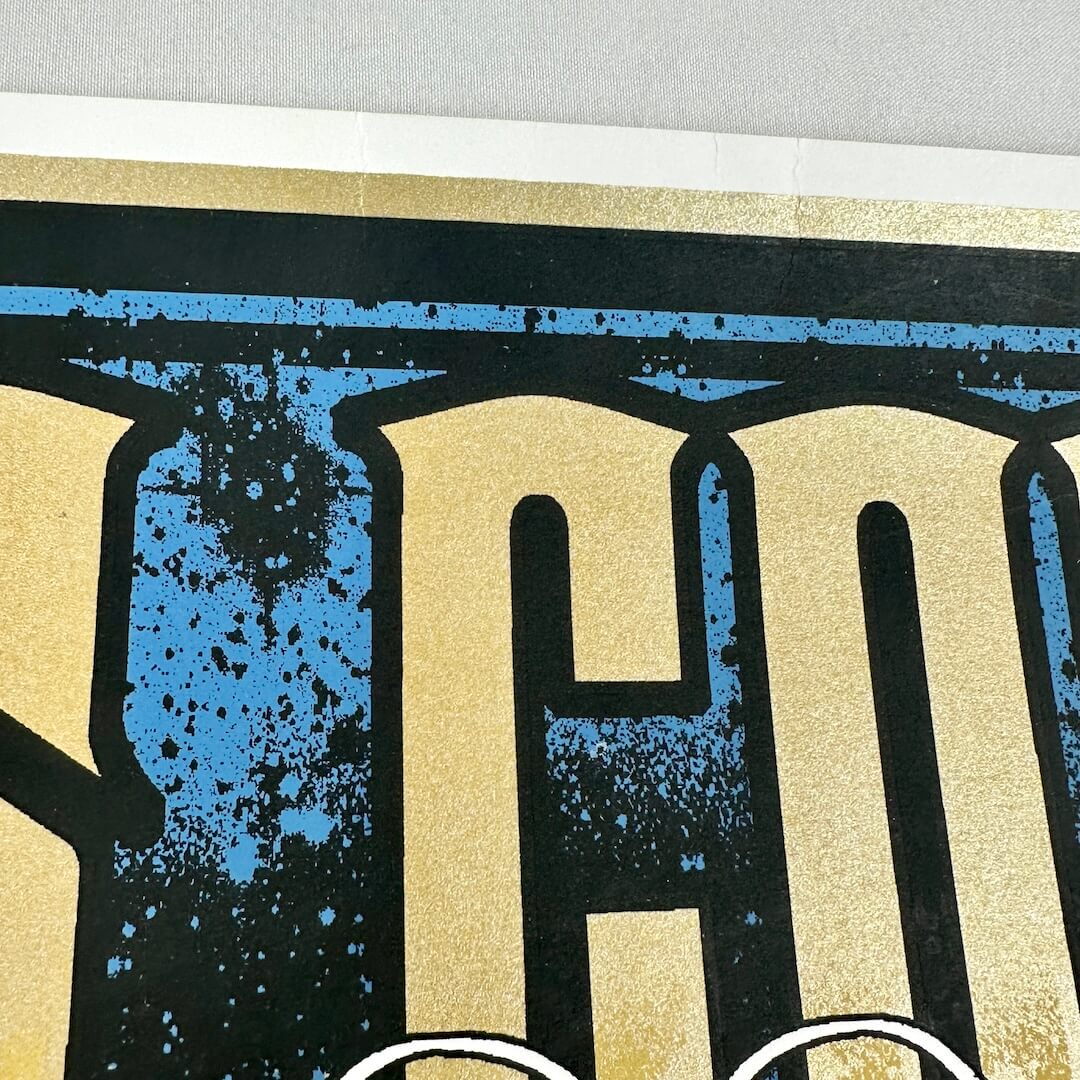 Top center of poster with small creases. 