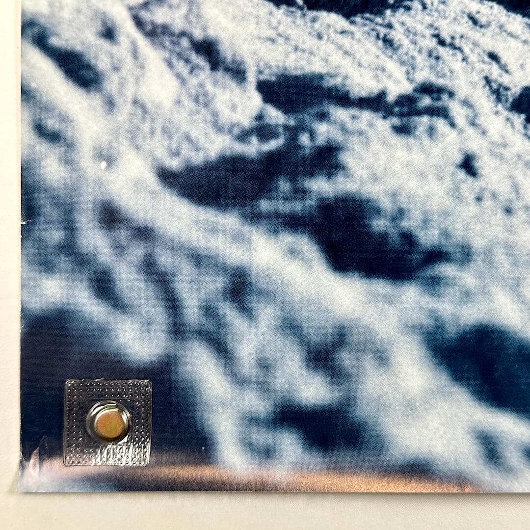 Bottom left corner of poster with small creases. 