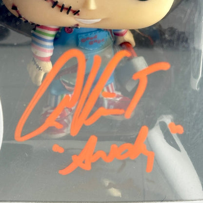 Toy figure in a clear plastic packaging with orange signature text.