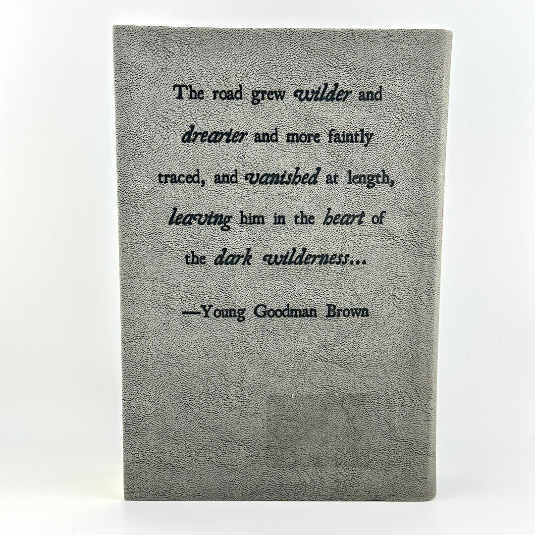 Textbook with a quote by Young Goodman Brown on a white background