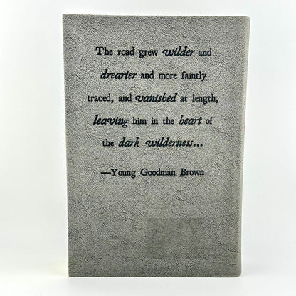 Textbook with a quote by Young Goodman Brown on a white background