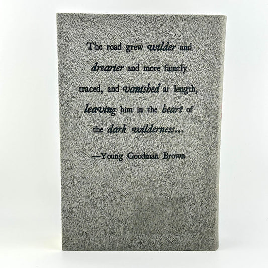 Textbook with a quote by Young Goodman Brown on a white background