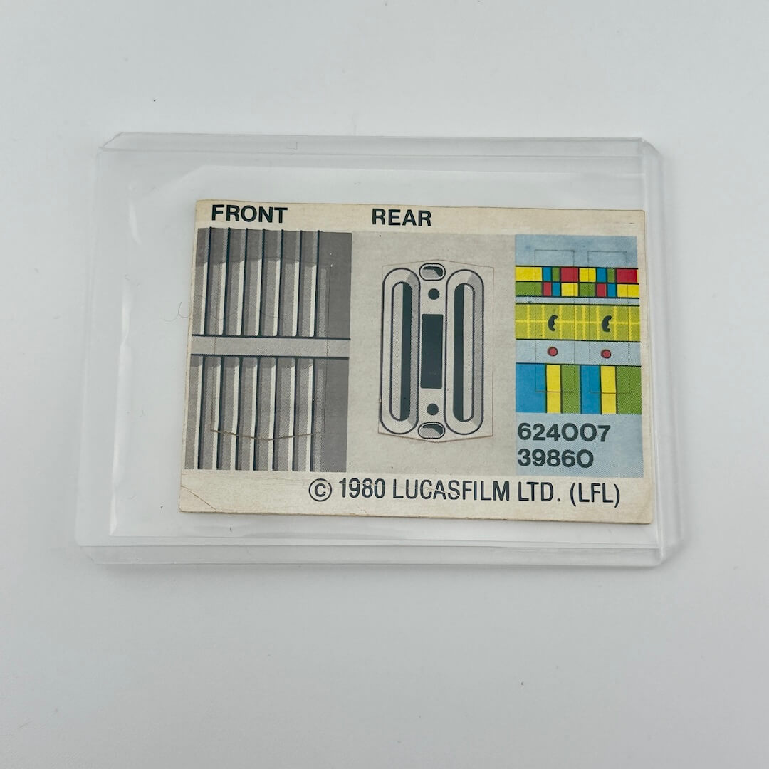 Vintage Lucasfilm Ltd. product label with front and rear views on a beige background, in protective sleeve.