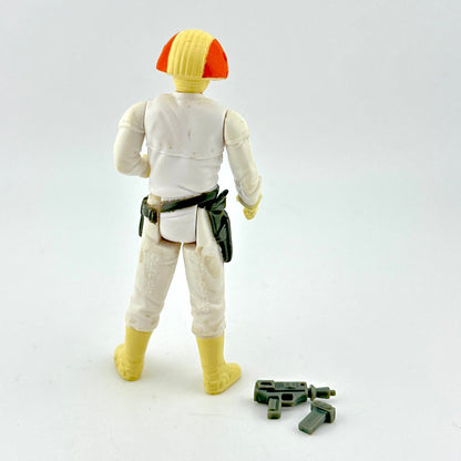 Toy figure in white outfit with two gray accessories on white background. 