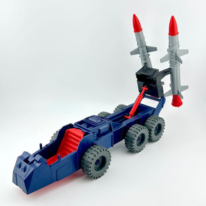 Blue and red toy vehicle with giant missiles on the back.