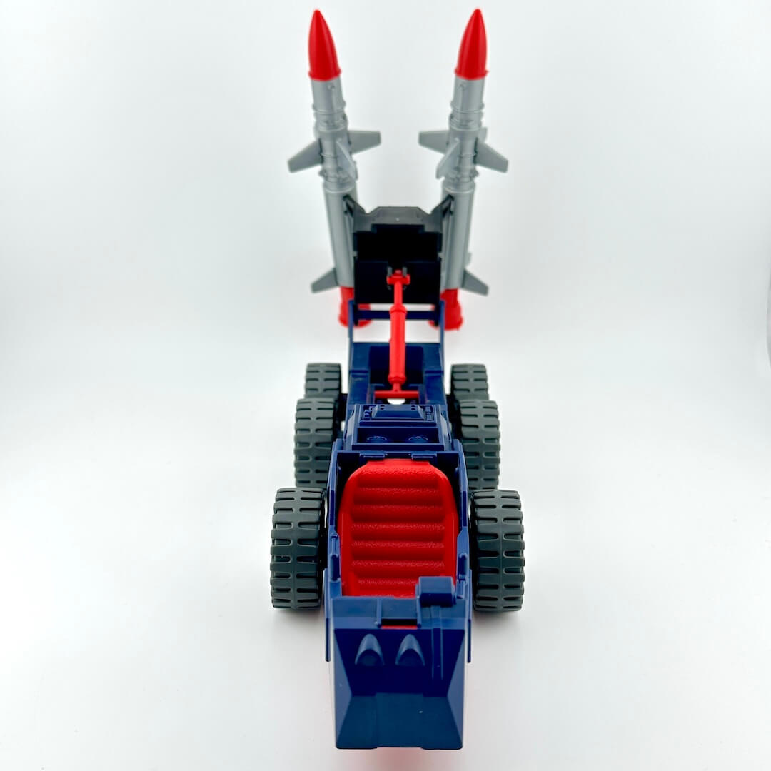 Blue and red toy vehicle with giant missiles on the back.