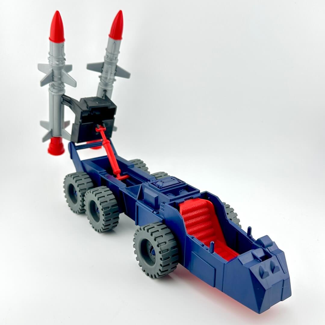 Blue and red toy vehicle with giant missiles on the back.