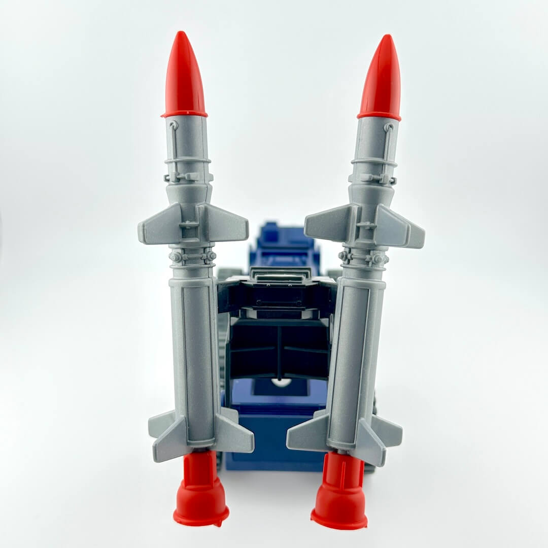 Blue and red toy vehicle with giant missiles on the back.