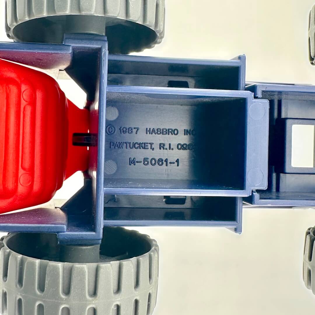 Blue and red toy vehicle with giant missiles on the back.