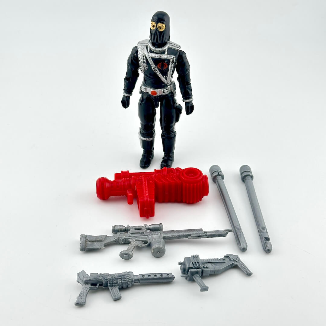GI Joe Cobra Commander action figure in all black with silver accents, pictured with silver and red accessories. 