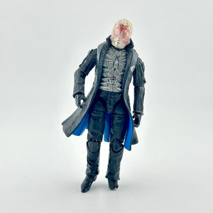 Action figure in black coat lined in blue with clear mask and silver armor on white background. 