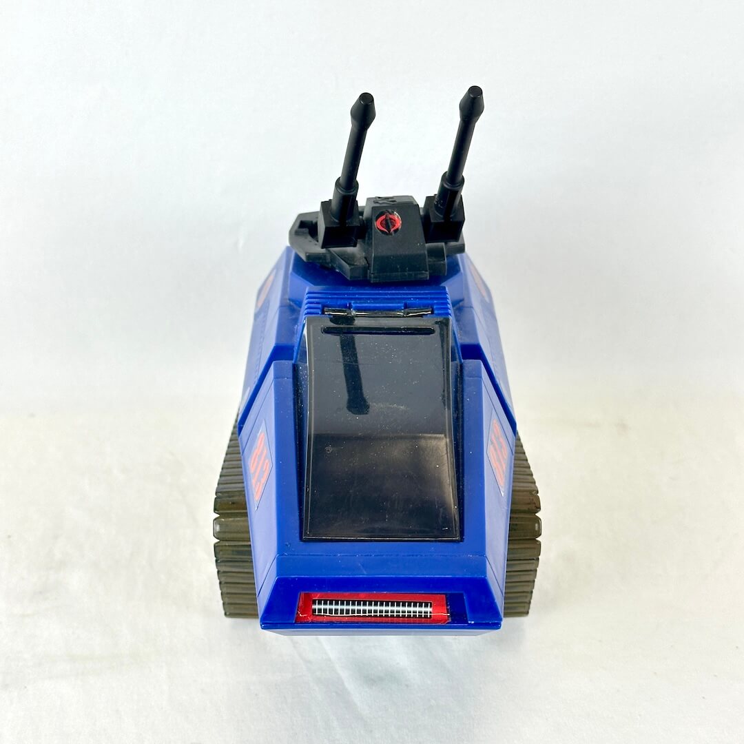 Frontal view of blue and black toy tank with stickers on white background. 
