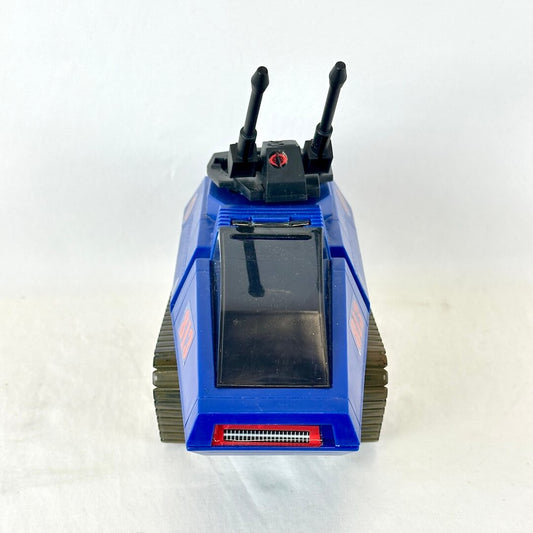 Frontal view of blue and black toy tank with stickers on white background. 