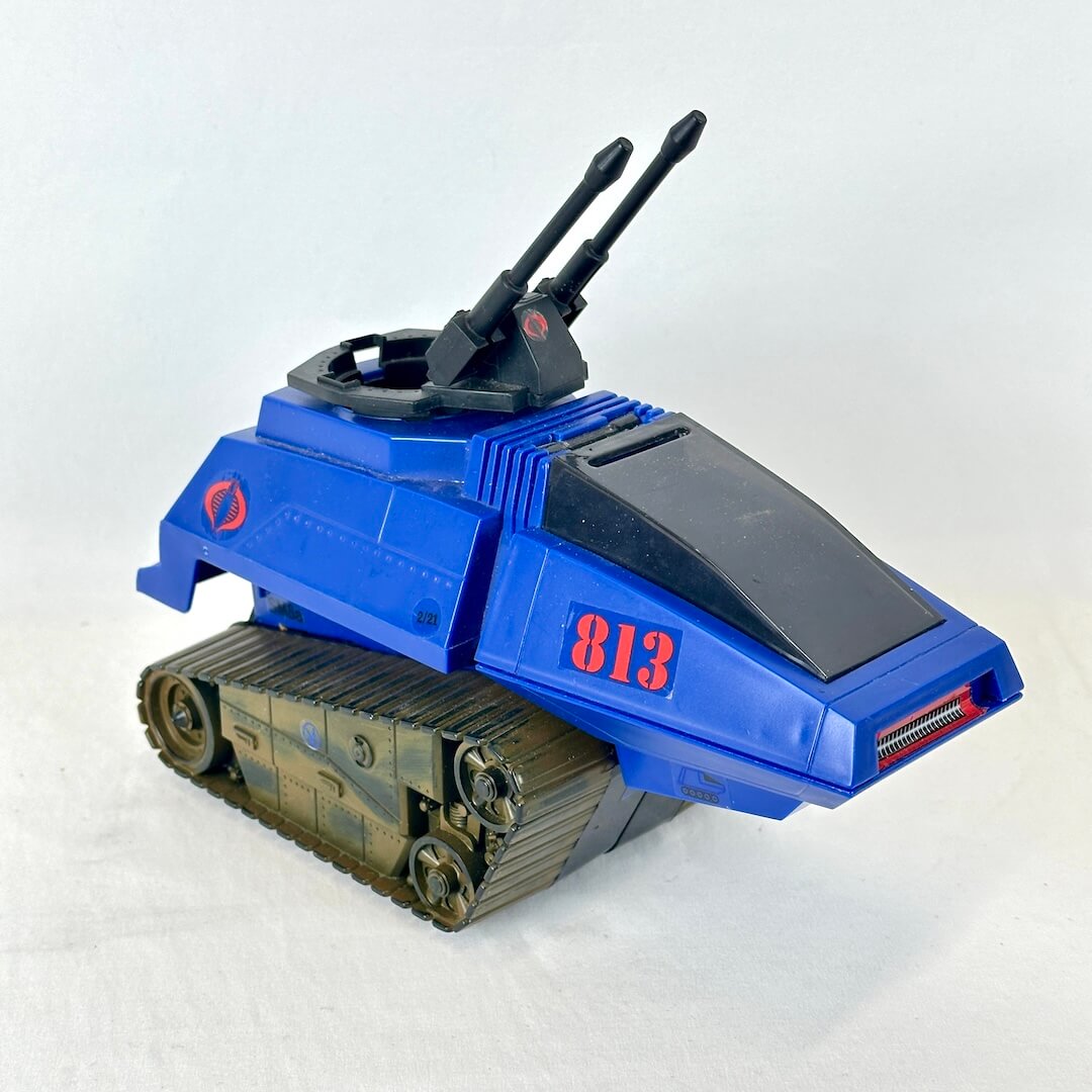 A blue toy tank vehicle with olive green treads, red '813' markings, and dual black gun barrels.