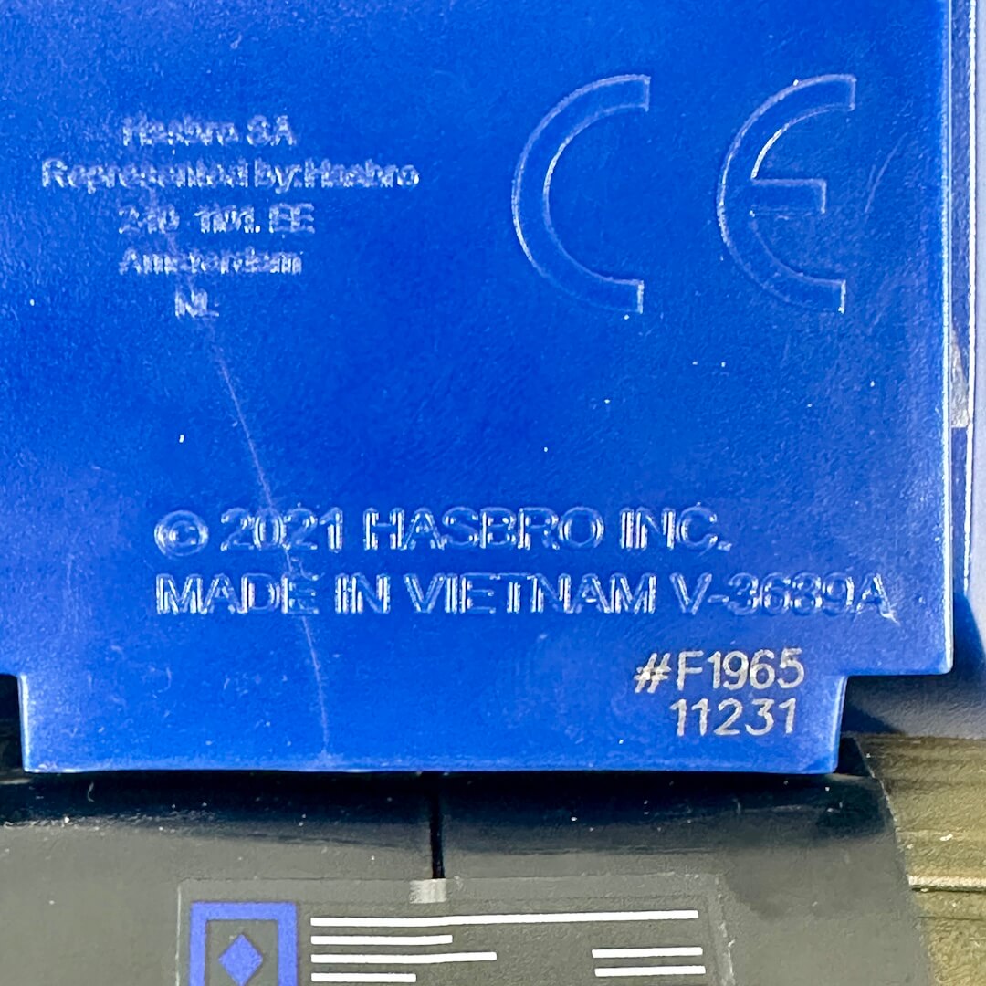 Close-up of embossed copyright and manufacturer information on underside of toy. 