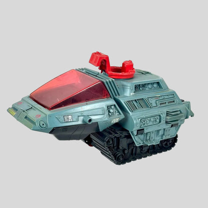 A toy tank vehicle with a light blue-gray body, a translucent red canopy, and black tracks, photographed on a plain light background.
