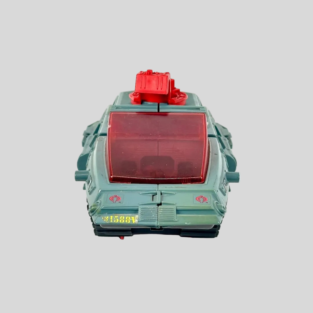 Vintage toy tank with red accents and green-gray body. 