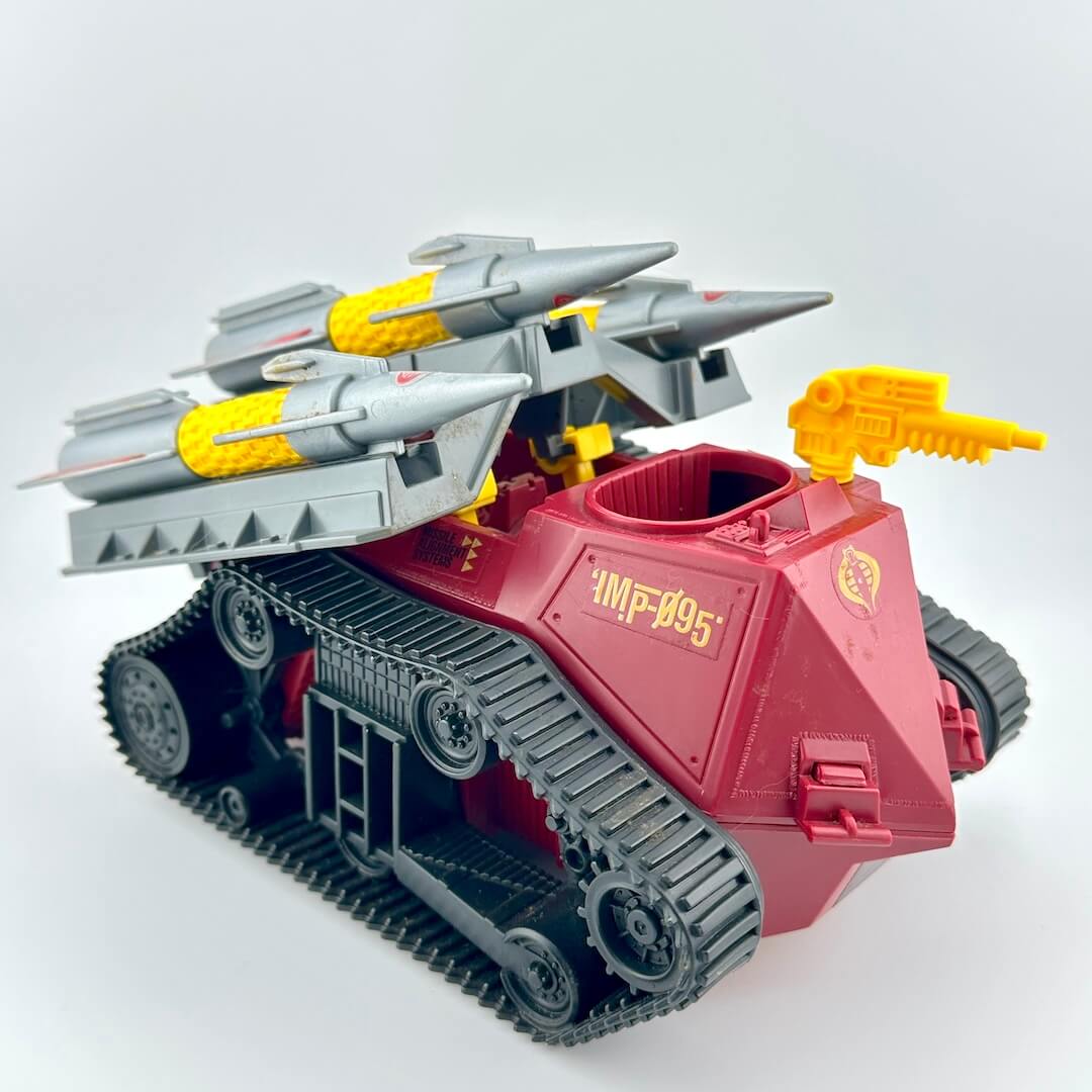 Toy tank model with missiles and a gun on a white background