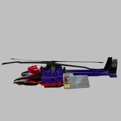 Purple & red toy helicopter with two black blades & tailfins, red missiles along side, & pilot ID card.