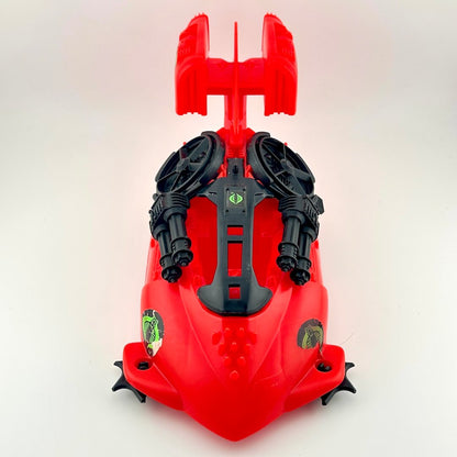 Red and black toy vehicle against white background. 