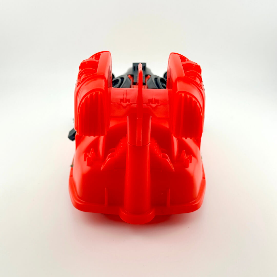 Red and black toy vehicle against white background. 