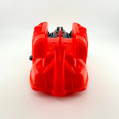 Red and black toy vehicle against white background. 