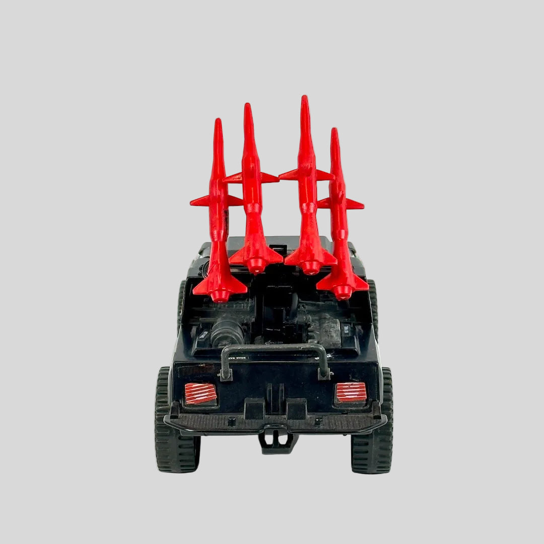 Toy vehicle with red missile-like appendages on a white background