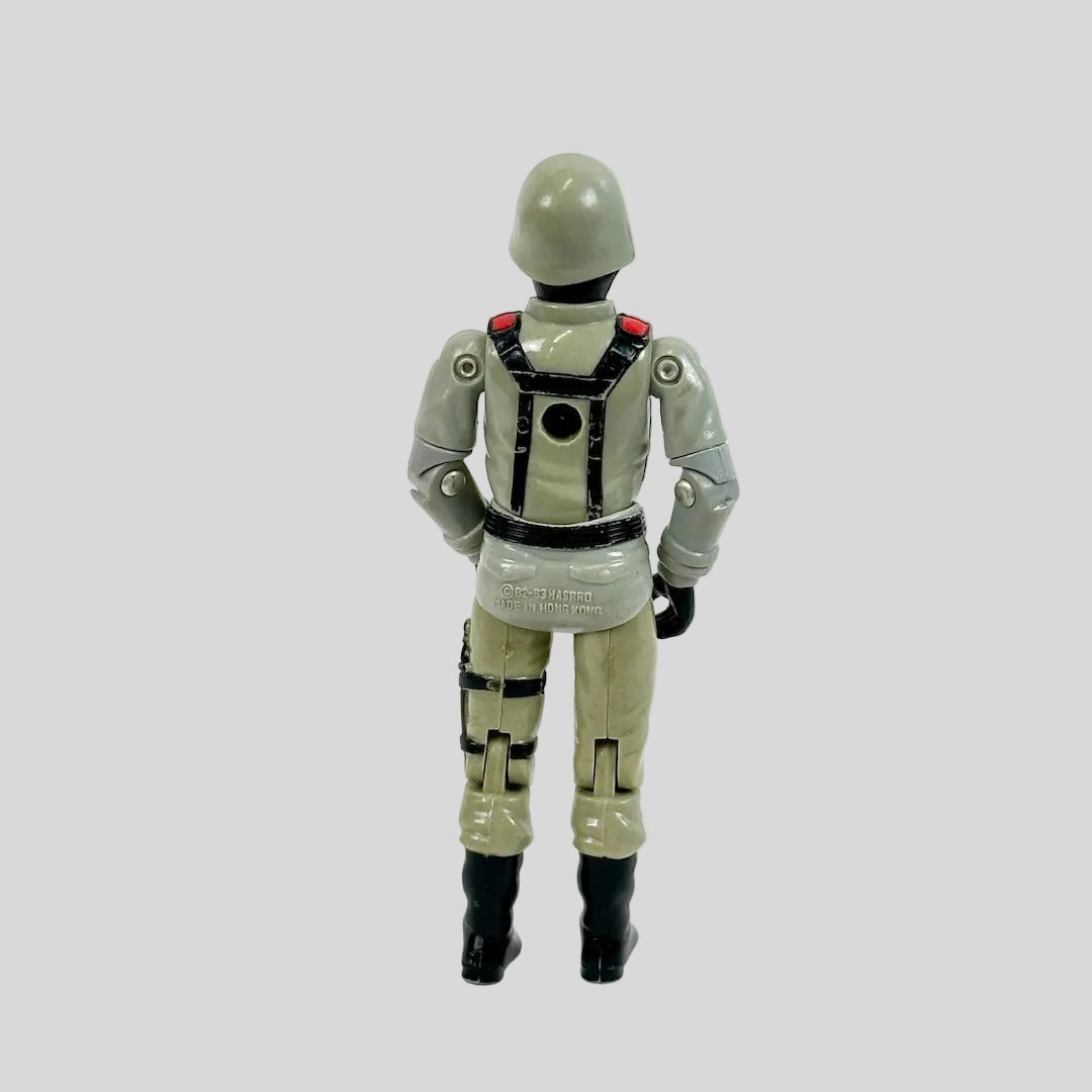 Toy figure of a character in a gray suit with black boots on a white background