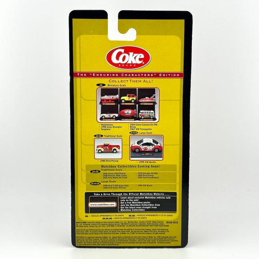 Packaged collectible diecast model car in its yellow and black retail blister card packaging, featuring the Coca-Cola logo.