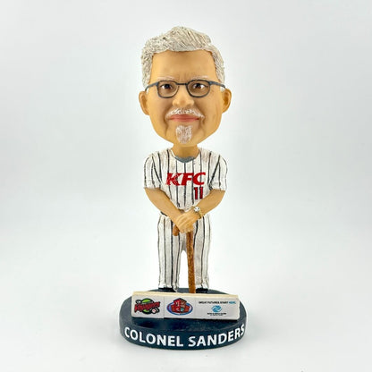 Bobblehead figure of a man in a KFC uniform with a white background