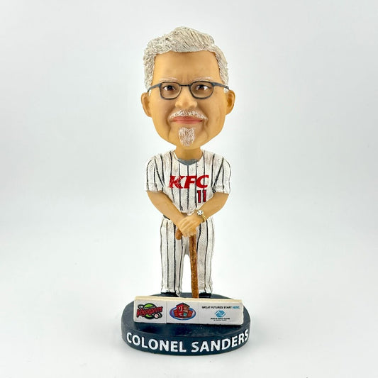 Bobblehead figure of a man in a KFC uniform with a white background