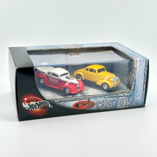 Hot Wheels Custom diecast toy cars in original window box packaging, featuring two cars in display window. 