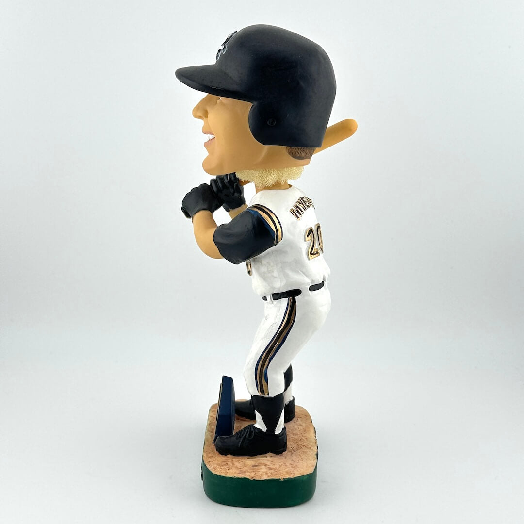 Baseball bobblehead figure in a white uniform with black accents on a light gray background