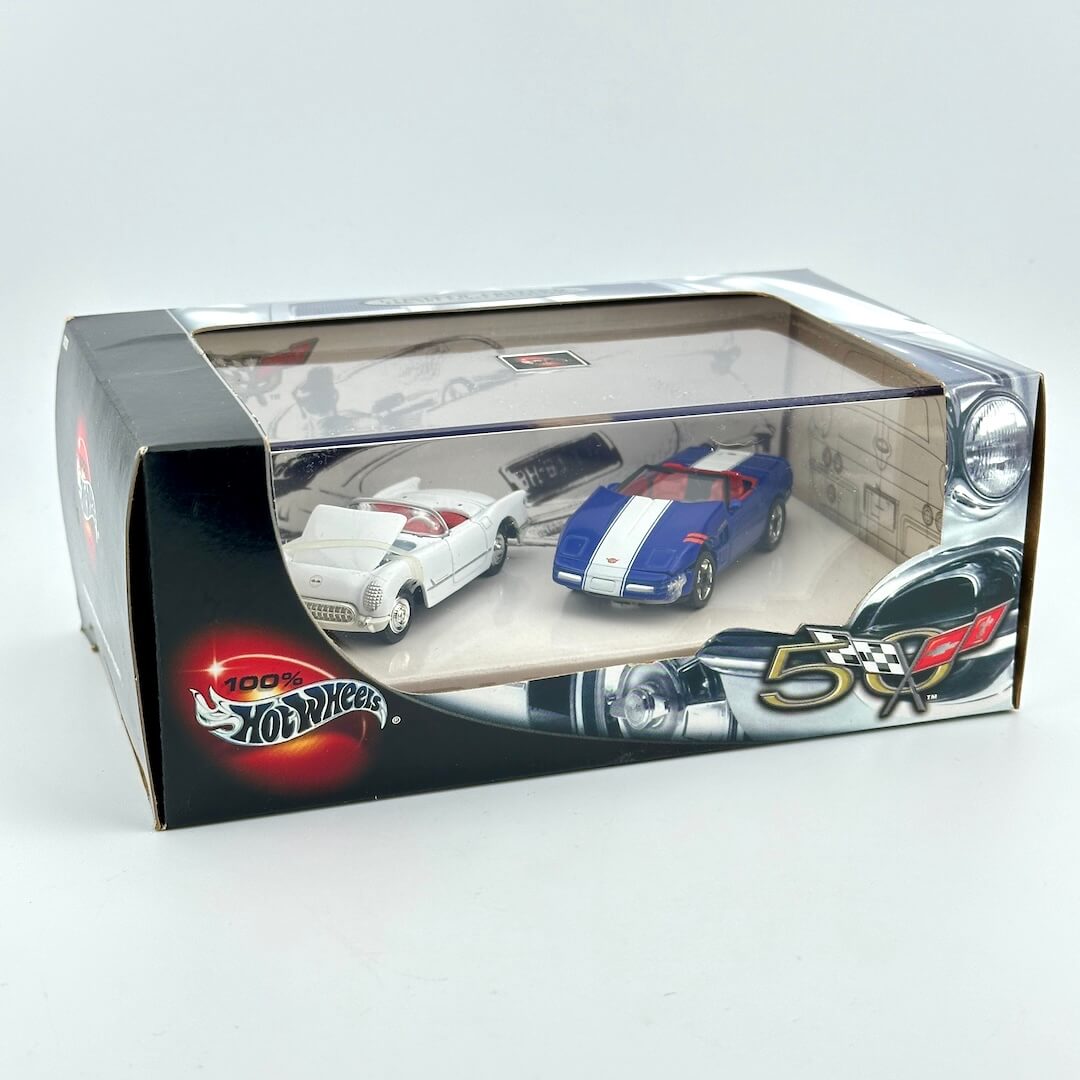 A boxed set of three miniature Hot Wheels die-cast toy cars visible through a clear plastic window on a plain light background. 