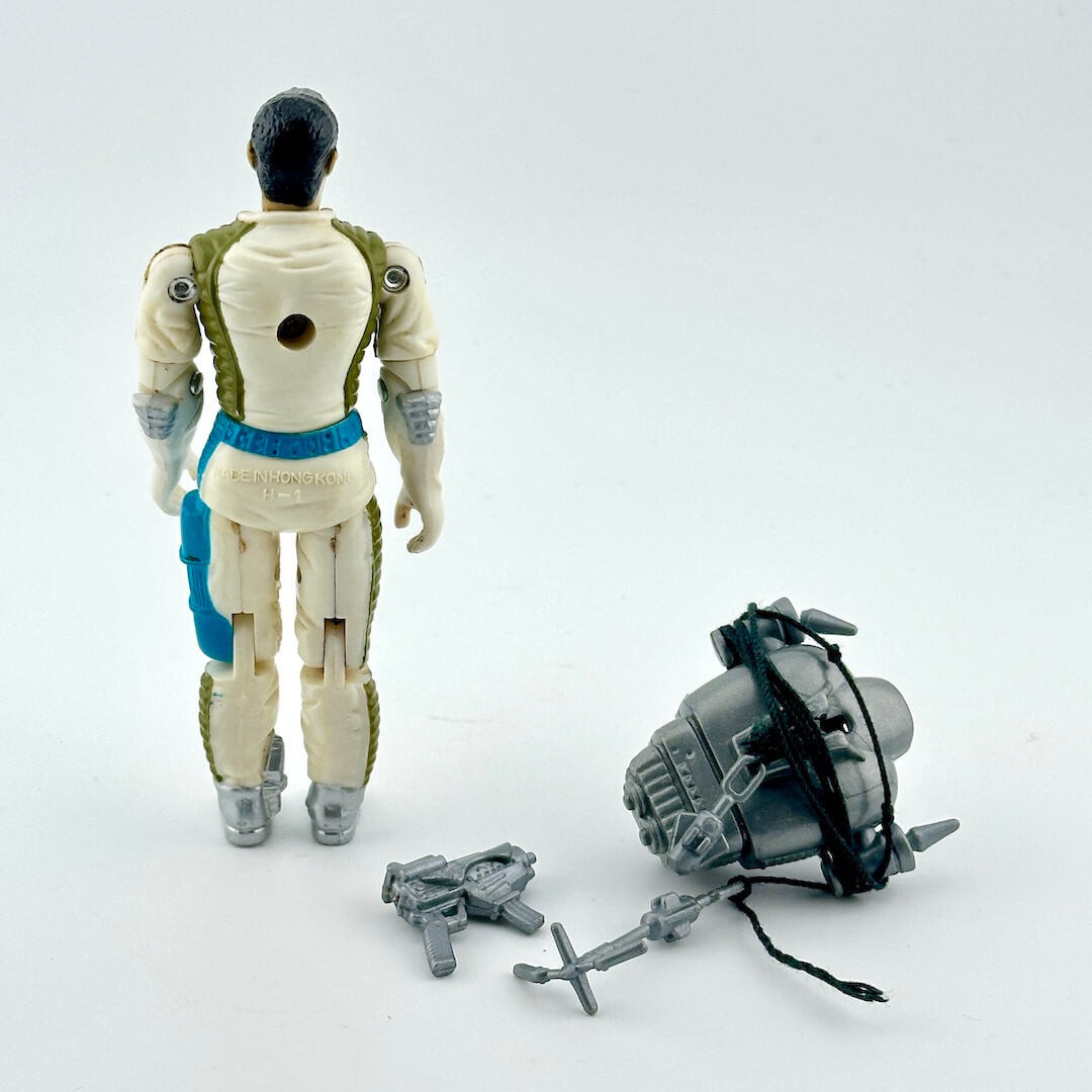 GI Joe action figure with accessories on white background. 
